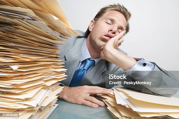 Businessman Office Worker Filing Asleep At The Job On Desk Stock Photo - Download Image Now