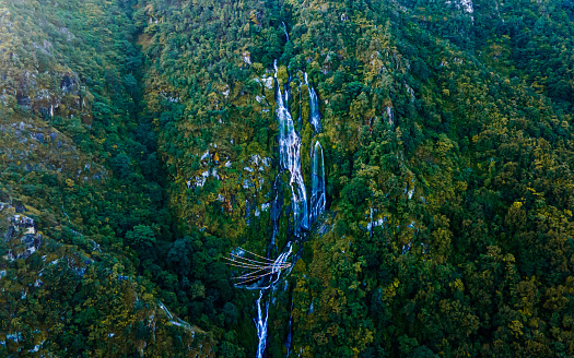 Drone view of Tindhare waterfall in middle of forest, Kavre, Nepal.