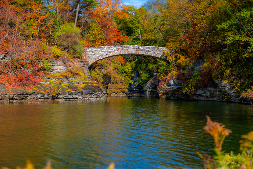 Autumn image of a bridge over the Beebe Lake in Ithaca NY.