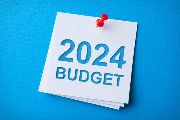 istock Budget 2024 Word in White Sticky Note on Blue Chardboard Background 1738169862