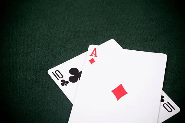 "A Ten and an Ace -- a winning Blackjack hand. Vignetting used to draw attention to the cards. Green felt gaming table.Blackjack, also known as Twenty-one, Vingt-et-un (French for Twenty-one), or Pontoon is the most widely played casino  game in the world. Much of blackjack's popularity is due to the mix of chance with elements of skill, and the publicity that surrounds card counting (calculating the probability of advantages based on the ratio of high cards to low cards)."