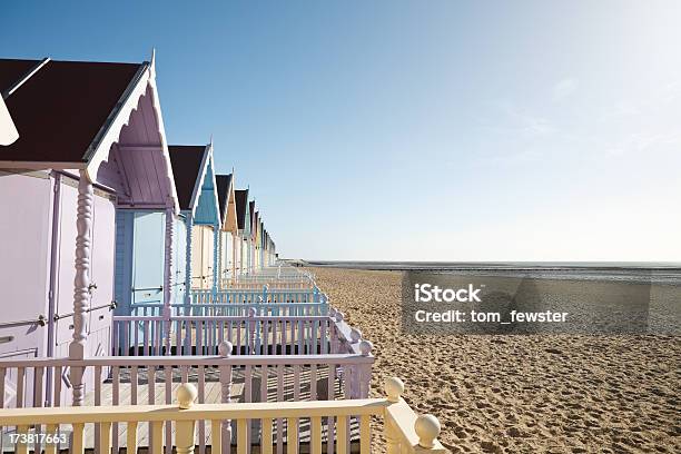 A Row Of Pastel Colored Beach Homes On The Sandy Shore Stock Photo - Download Image Now