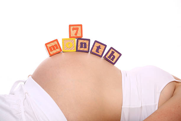 Seven month pregnant stock photo