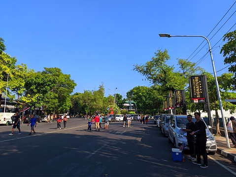 “Semarang, Indonesia – August 13, 2023 : People flock to the Indonesia Kaya Park area and Simpang Lima to exercise and go for a walk on Sunday mornings in the city of Semarang, Central Java, Indonesia\