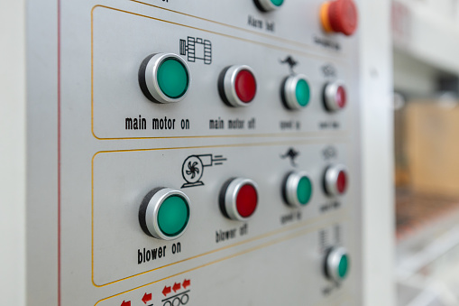 Power button on panel control machine. Pressing work button. Engineering are working on turning on machines in industrial plants.