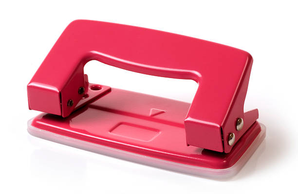 Red hole puncher stock photo