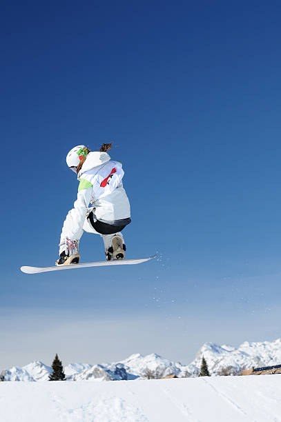 istock Female snowboarder flying 173819120