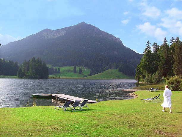 wellness at mountain lake with man with bathrobe