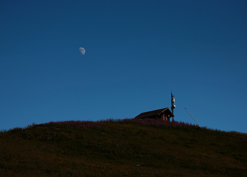 view of a moonrise in the mountains in summer