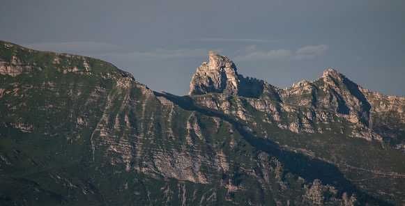 view of a mountain peak and clouds in summer