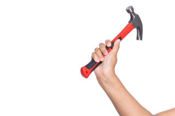 istock Woman's hand holding hammer isolated on white background 1738207289