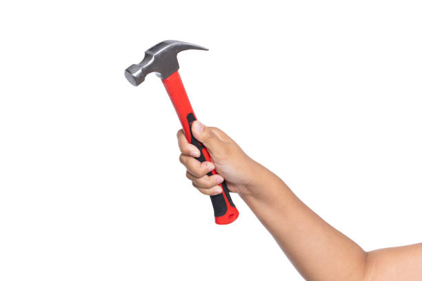 istock Woman's hand holding hammer isolated on white background 1738207297