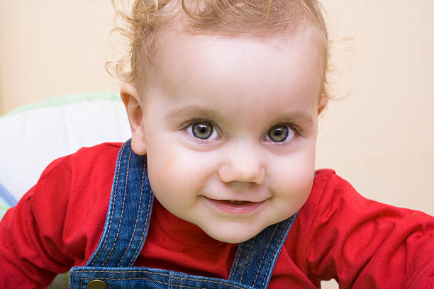 Baby girl staring at the viewer stock photo