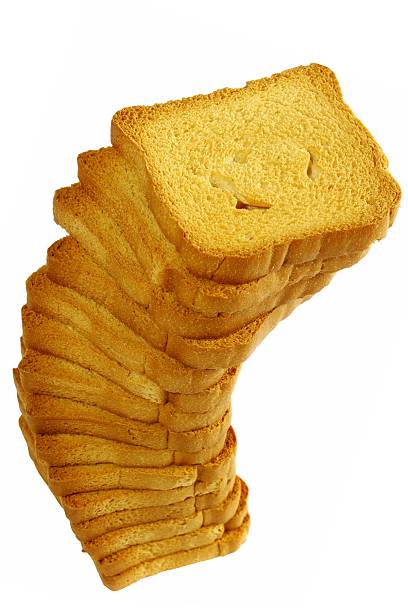 Stack of rusks - isolated on white "close up of a stack toast, isolated on white. Zwieback Turmzwieback stacks, white background" zwieback toast stock pictures, royalty-free photos & images