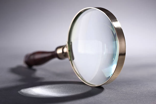 Magnifying glass over isolated background Closeup of magnifying glass over isolated background concave stock pictures, royalty-free photos & images