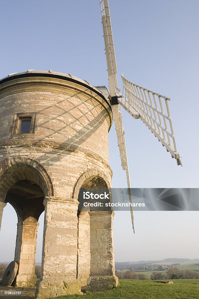 Chesterton Windmill Warwickshire "Erected out of local hard limestone with sandstone details, in 1632 to a design attributed to the famous architect Inigo Jones. The windmill is one of Warwickshire's most famous landmarks, standing on a hilltop near Warwick for nearly 350 years. It was built in 1632-1633, by Sir Edward Peyto and  it remained in working order until 1910.  It is the earliest tower mill in England to retain any of its working parts, following itaas successful restoration in the 1960aas. The design is unique, being supported on six arches and mechanically unique, with wooden gearing." 17th Century Stock Photo