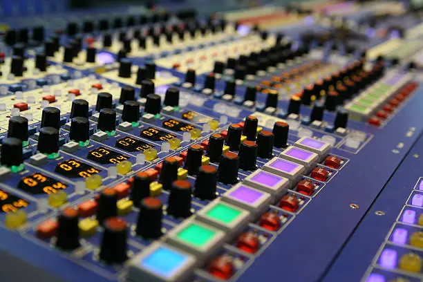 Selective focus on colorful sound mixer panel