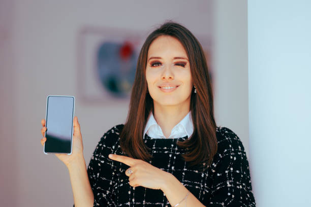 istock Woman Holding a Phone Pointing Index Finger at its Display 1738254045