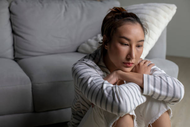 istock Female suffer from mental health problems, sitting on floor at home. 1738268063