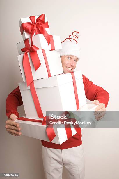 Улыбающегося Человека В Санта Шляпа Предоставление Праздник Рождественские Подарки — стоковые фотографии и другие картинки Белый