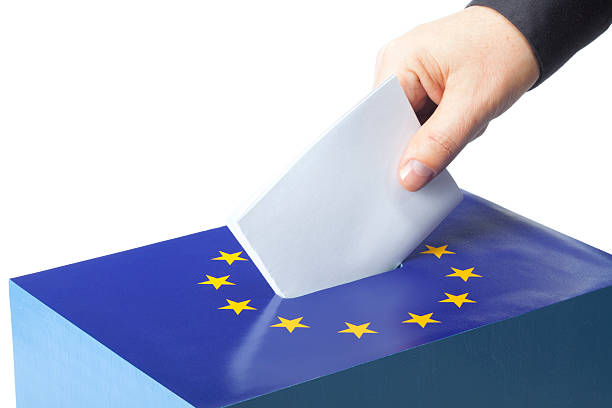 Male hand inserting ballot to EU ballot box