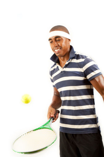 A young man playing tennis.