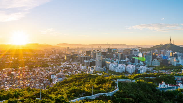 Time lapse Landscape of Seoul South Korea in the morning and the golden sun shines on the city.