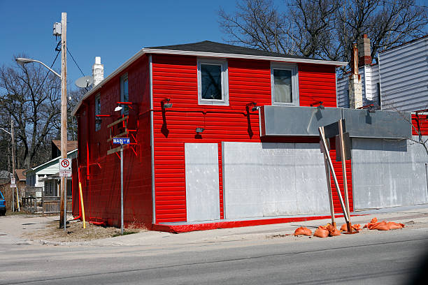 Three run down garages on a suburban road