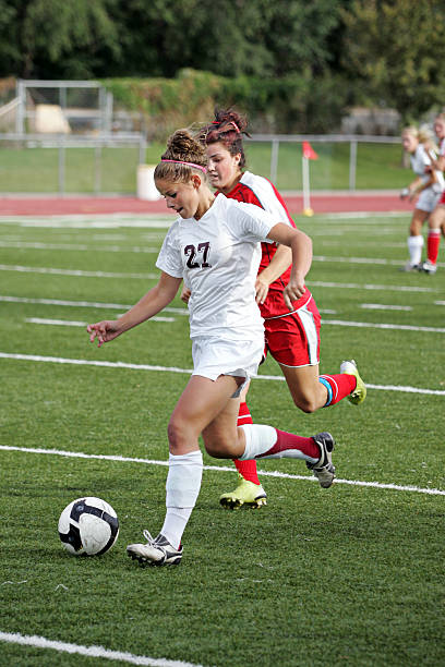 istock Female Soccer Attack with Shadowing Defender 173828470