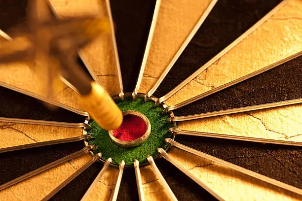 Photo of Dart on bulls eye target of dartboard