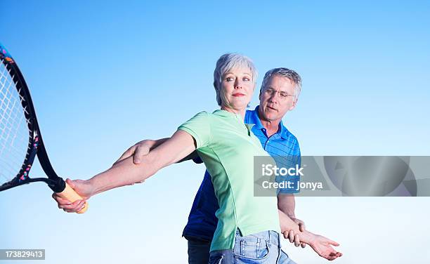 Husband Teaching His Wife To Play Tennis Stock Photo - Download Image Now - Low Angle View, Motion, Senior Men
