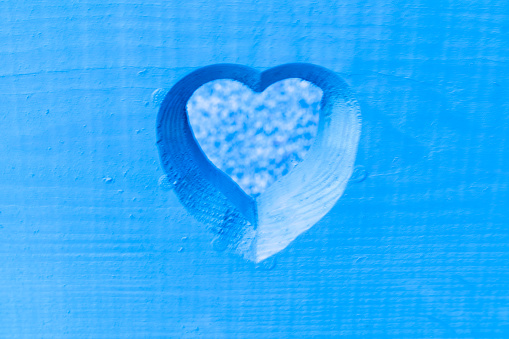 Blue heart cut out in wood