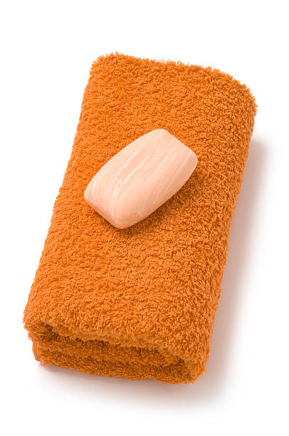 Towel and soap isolated on white