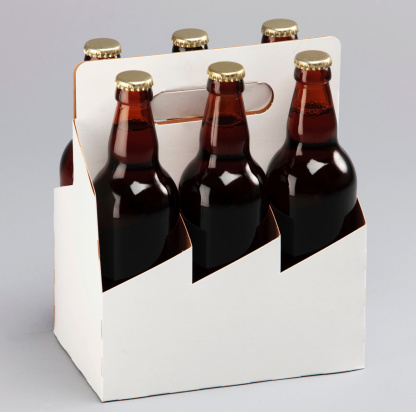 Bottles and glasses of beer on white background. Pouring beer into one glass