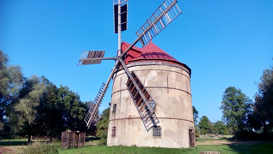 old windmill for the production of flour, original structure, restored blades