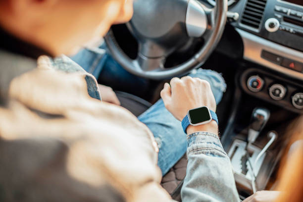 smart watch on the hand of car driver, close up. transport, business trip, technology, time and people concept stock photo