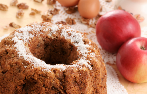 A delicious apple nut cake with some of it's main ingredients in the background. Shallow DOF, focus on the front edge of the cake.  (Adobe RGB)