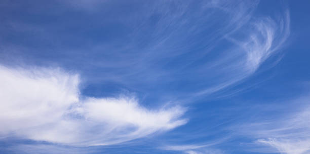 Beautiful blue sky with white wispy clouds Photo of a blue sky background and some wispy white clouds stratosphere meteorology climate air stock pictures, royalty-free photos & images