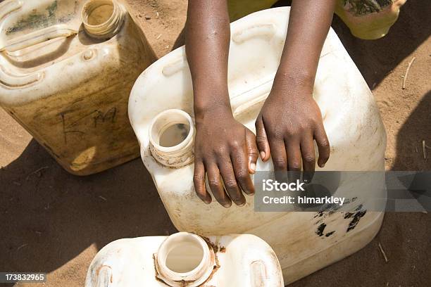 Childs Hands Over Water Jug Stock Photo - Download Image Now - Unhygienic, Water, Africa