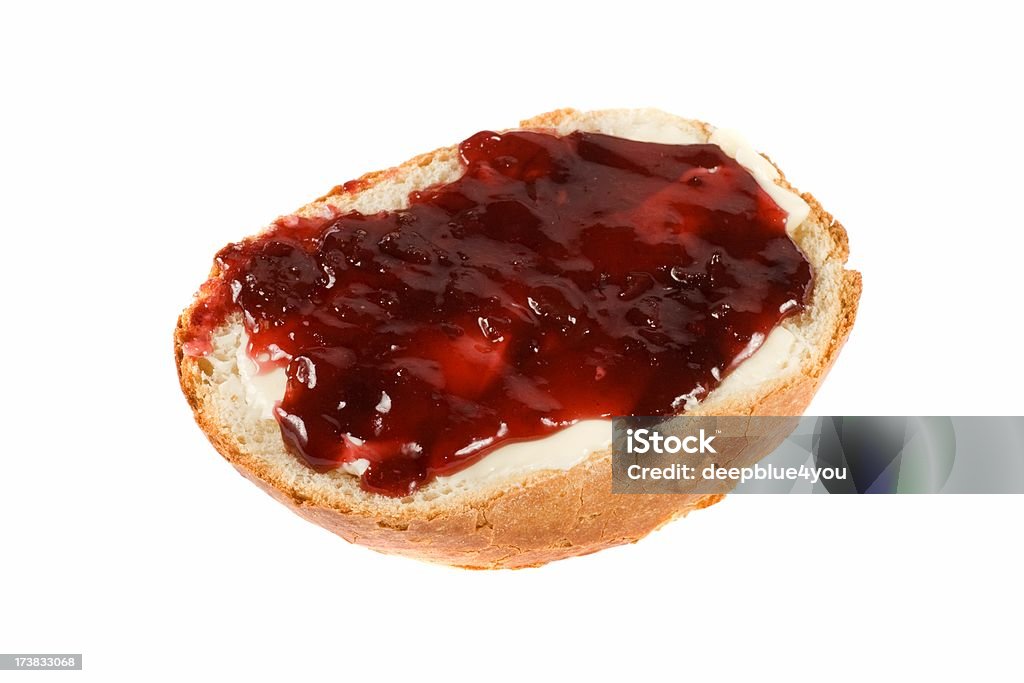 golden bun with red jam isolated on white background close up of a cherry marmealade bun, white backgroundclose up of a gold brown baked bun Preserves Stock Photo