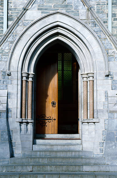entrance of a gothic chapel The entrance of a gothic chapel near Kylemore Abbey in Ireland. Typical early Gothic architectural style. Open door. kylemore abbey stock pictures, royalty-free photos & images