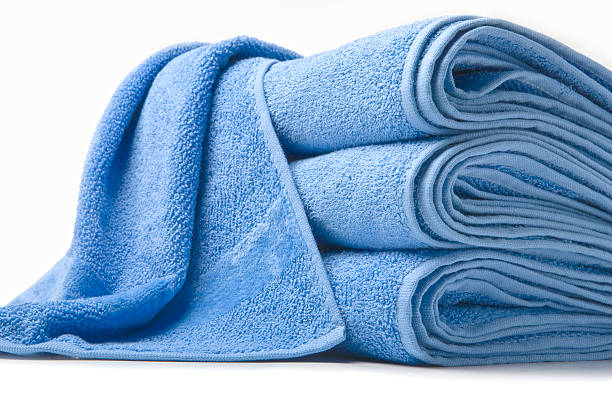 istock Stack of three blue towels and one thrown on top  173833663
