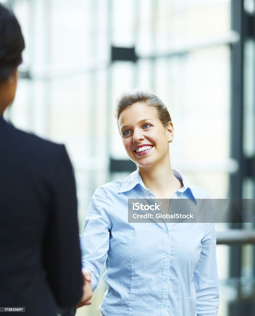 Business colleague shaking hands and smiling 20-29 Years Stock Photo