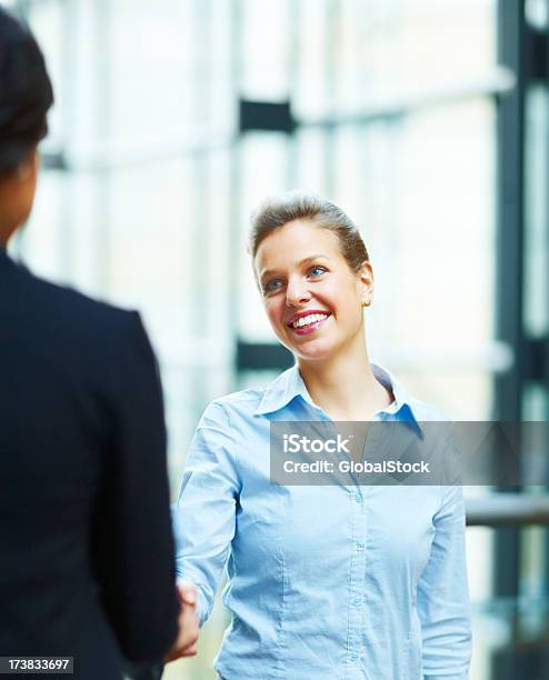 Business Colleague Shaking Hands And Smiling Stock Photo - Download Image Now - 20-29 Years, 25-29 Years, Achievement