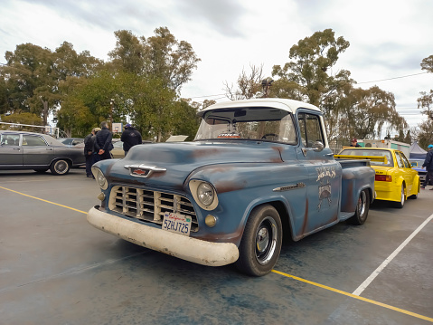 Lanús, Argentina - Sept 24, 2023: Old blue utility 1956 Chevrolet 3100 pickup truck Task Force stepside bed by GM in a park. Classic car show.