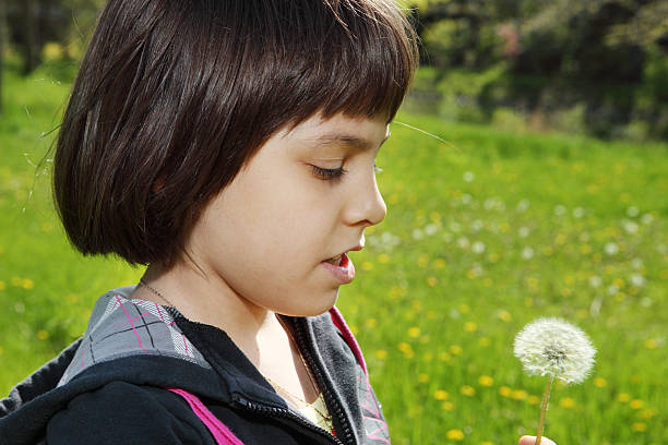 istock Girl with dandelion 173834688