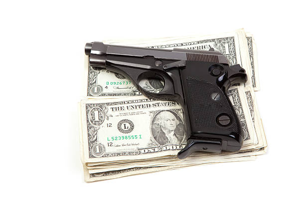 istock Pistol and dollars 173835400