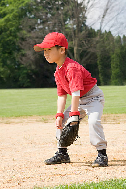 istock Young Asian Boy Plays Baseball or T-ball 173835614