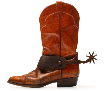 A profile view of a cowboy boot and spurs. Clipping path included.
