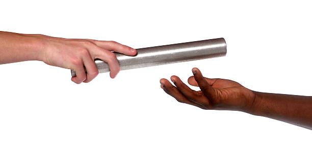 istock Two hands, giving and receiving a track baton in a race 173836054